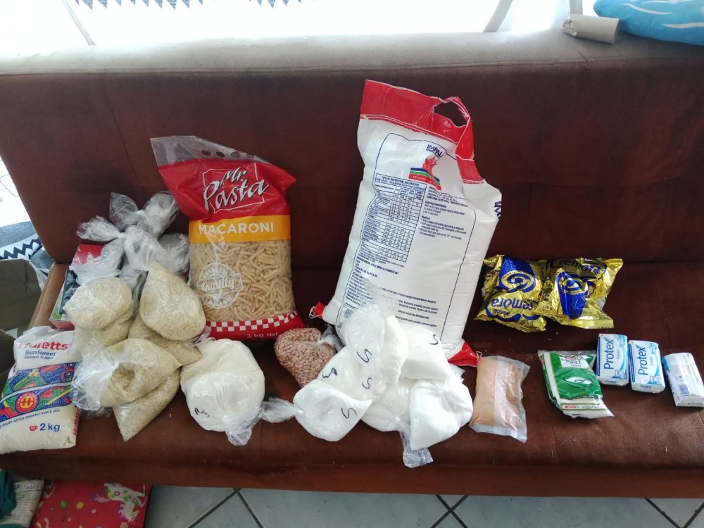 Food parcel donation with flour, cooking oil, peanut butter, and jam